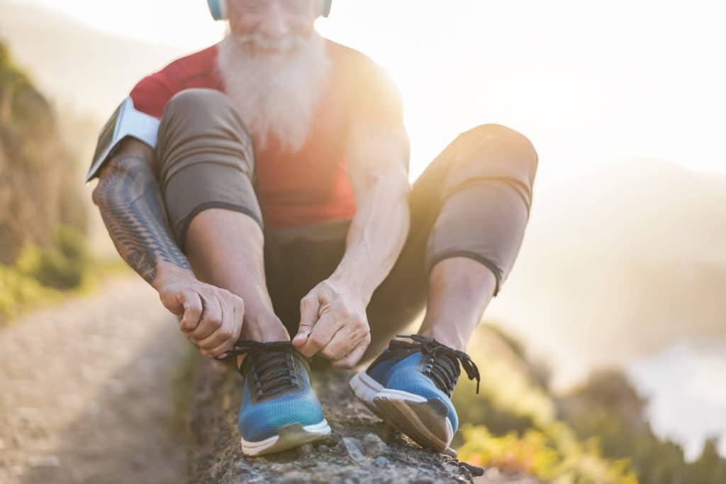 Man tying running shoes exercise fibromyalgia