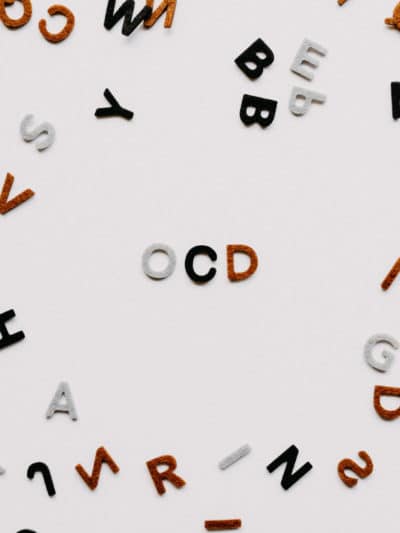CBD and OCD, A bunch of letters on a background with 3 distinct letters spelling OCD