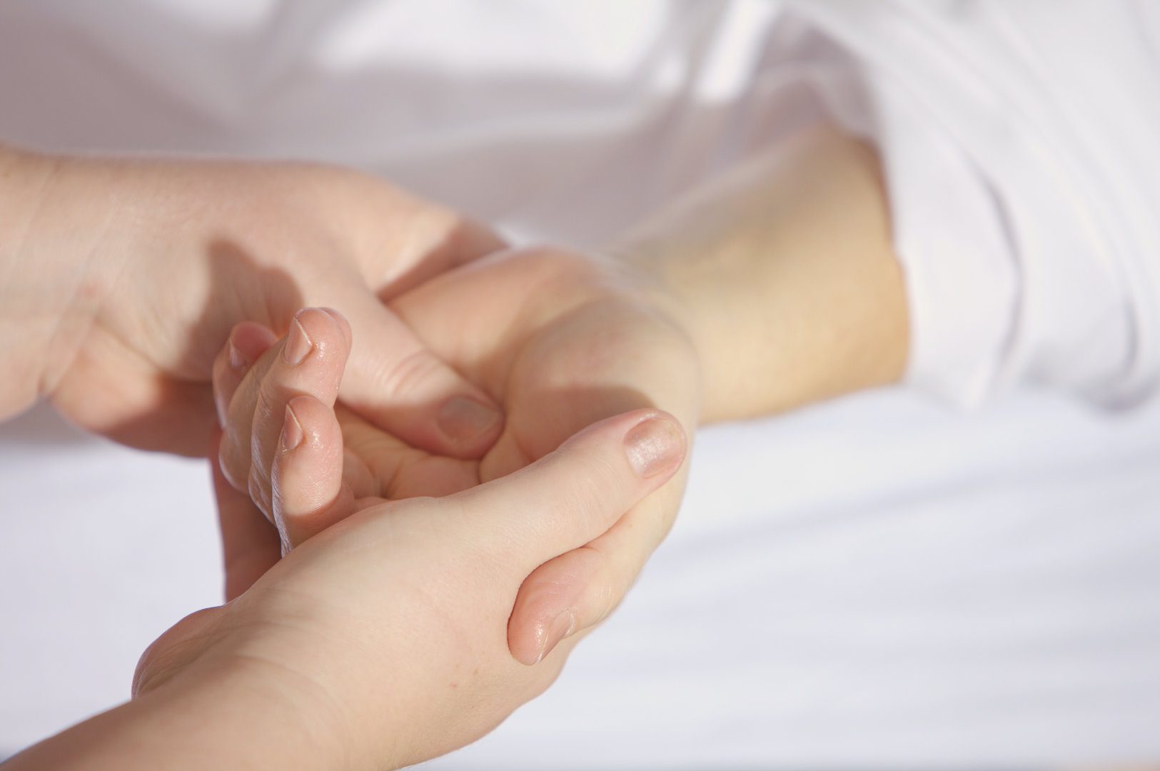 person massaging another persons wrist due to carpal tunnel