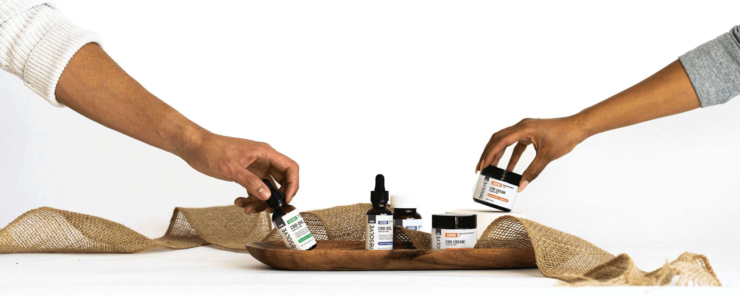 Hands reaching for resolveCBD products
