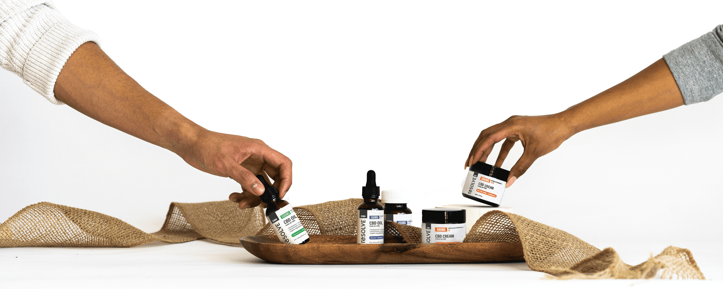 Hand Products Hands reaching for resolveCBD products