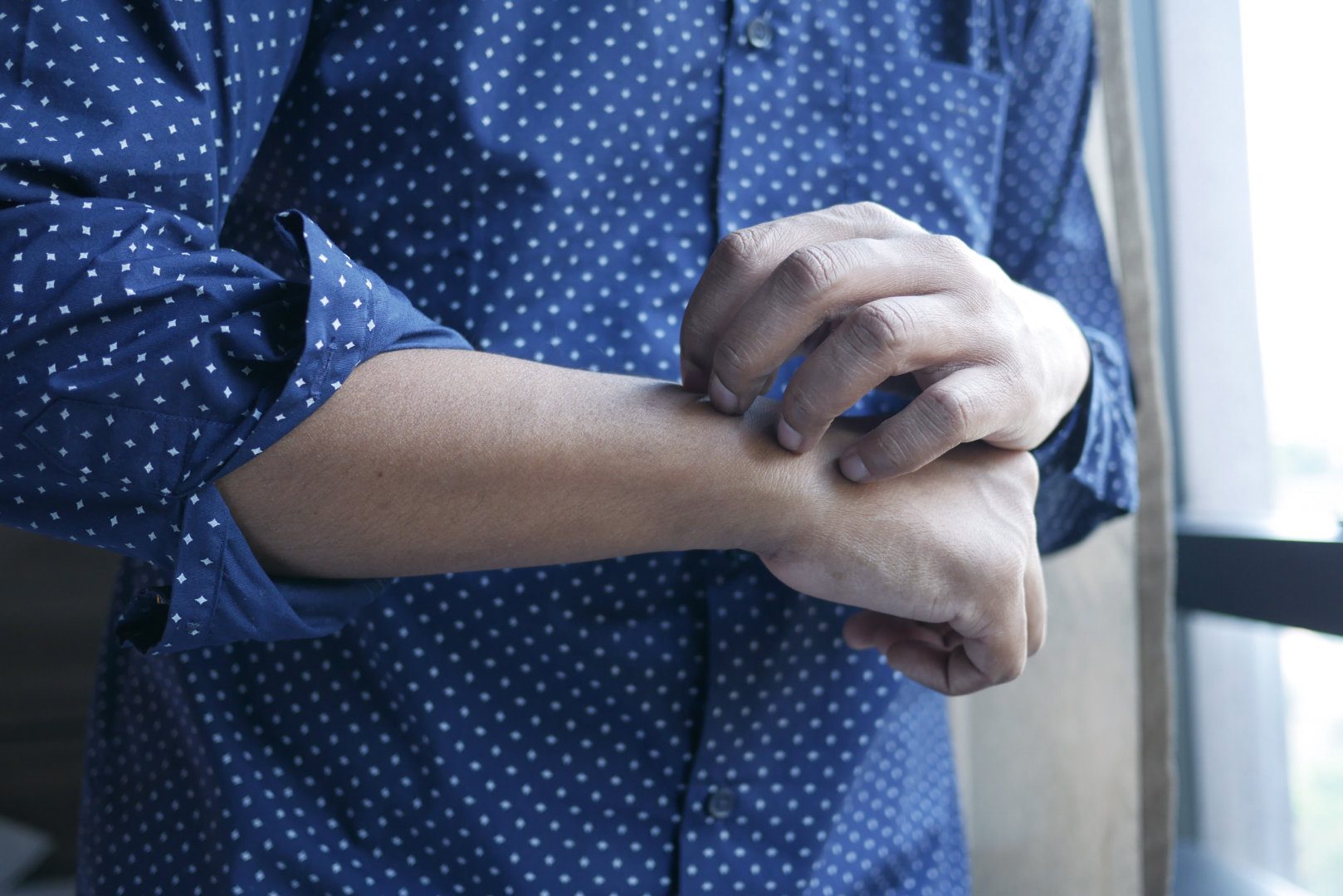 Person Scratching their Forearm