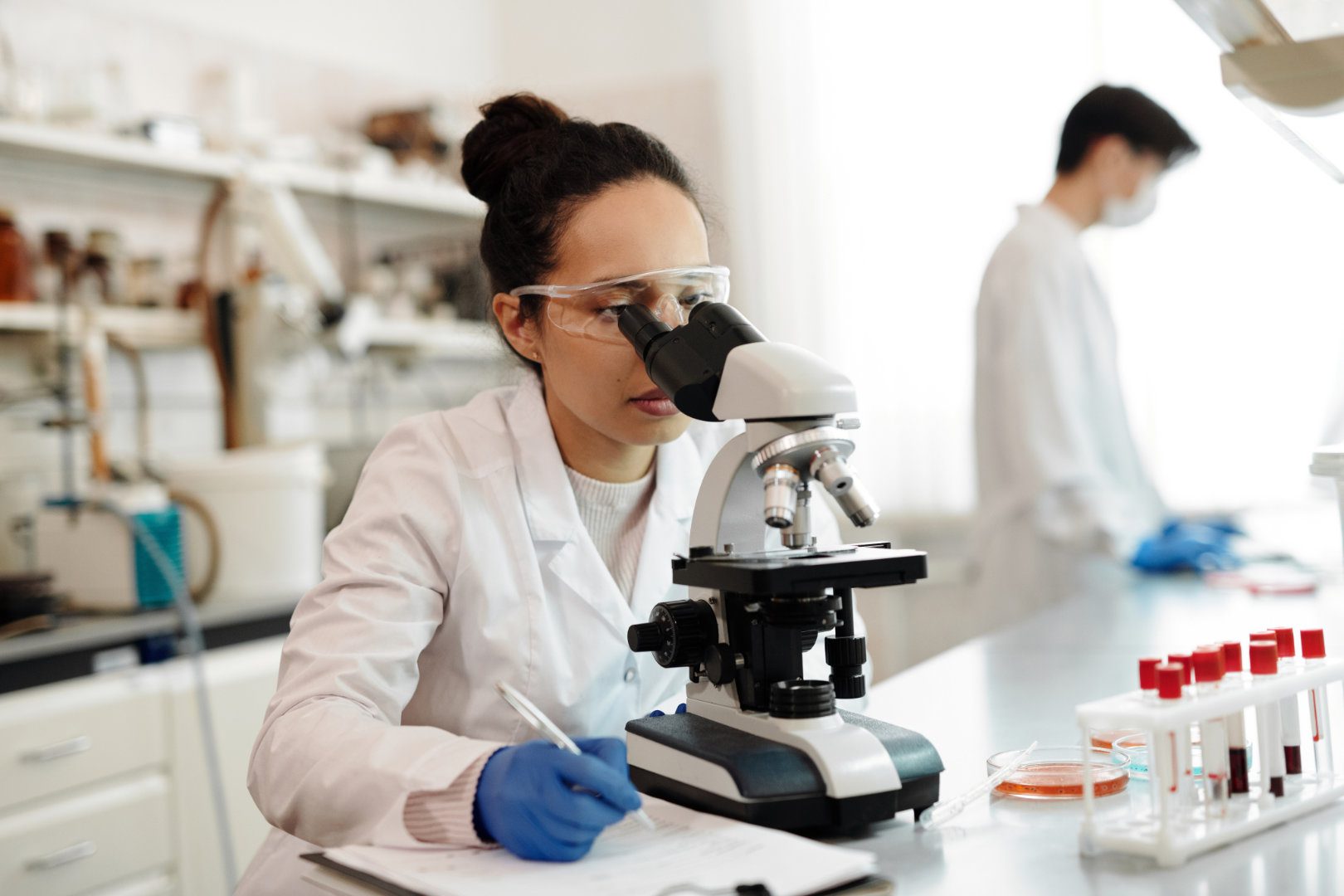 Scientist looking through a microscope in a laboratory