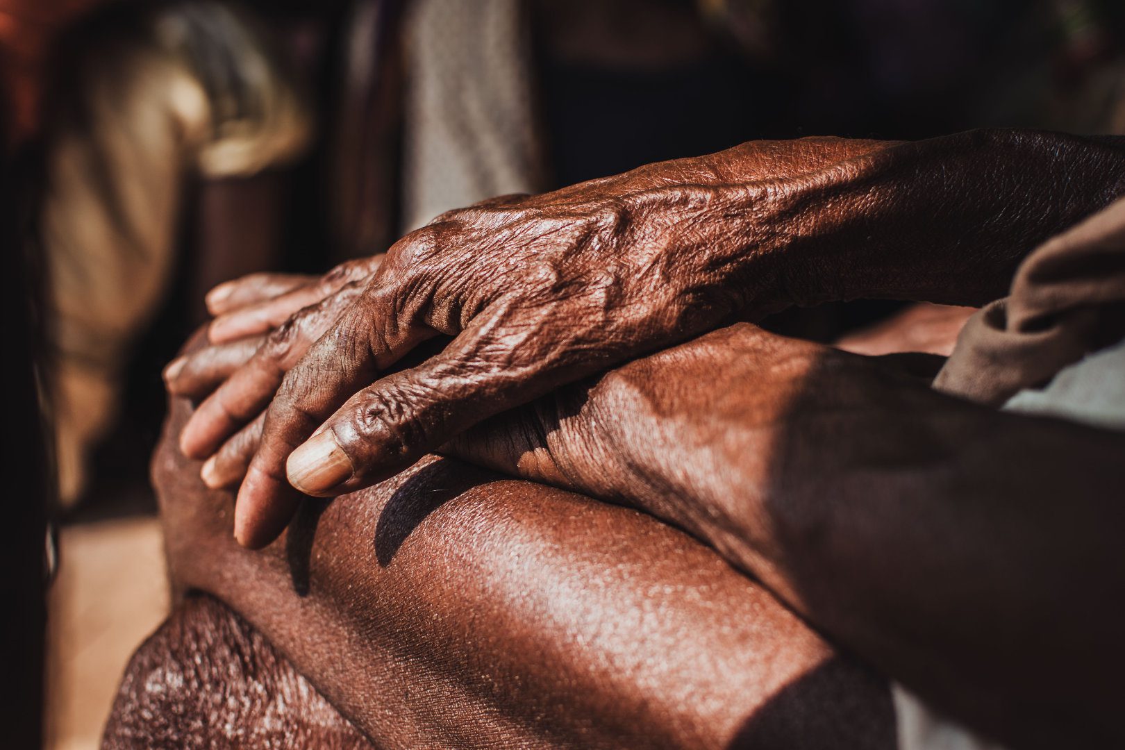 Elderly person holding wrist because of joint pain