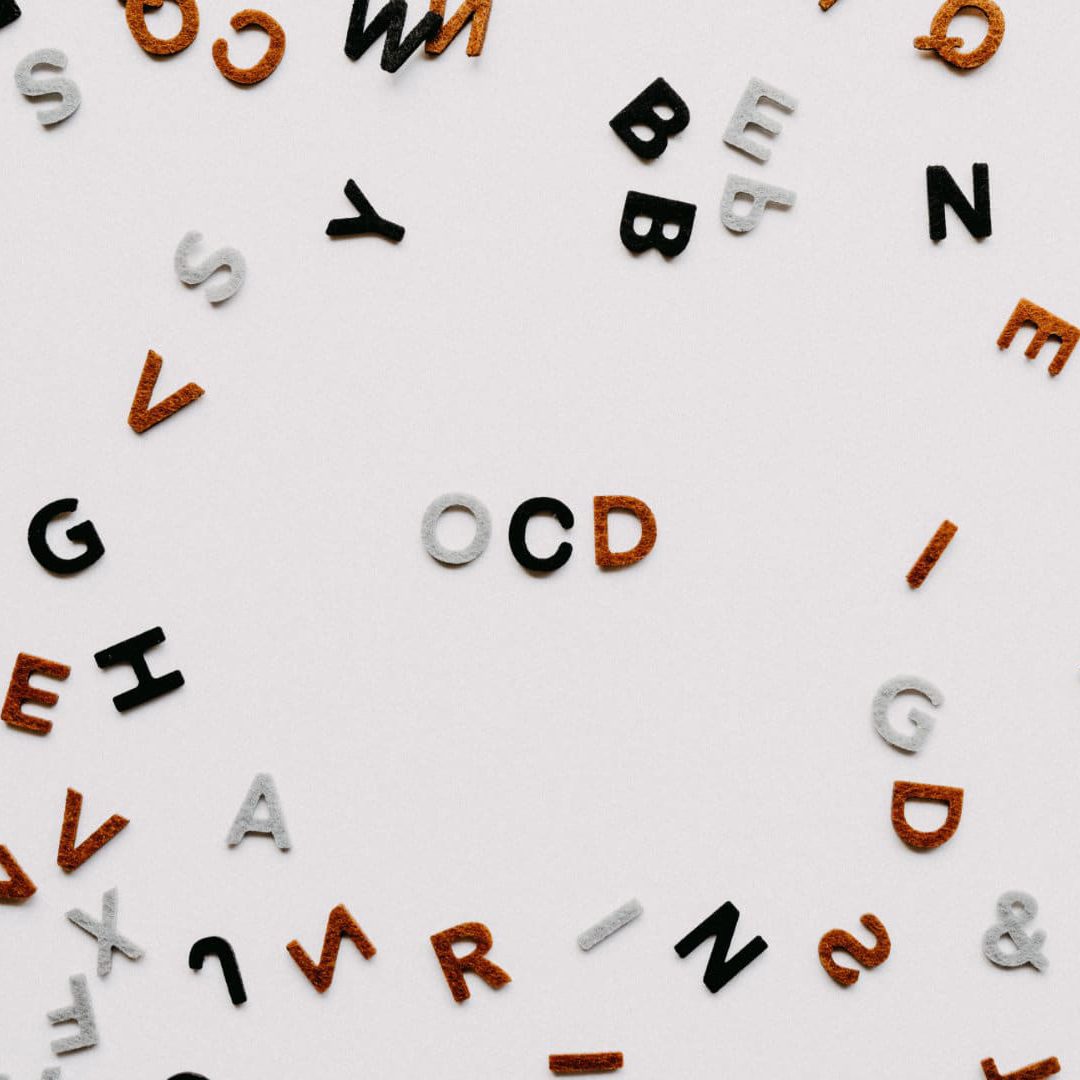 CBD and OCD, A bunch of letters on a background with 3 distinct letters spelling OCD